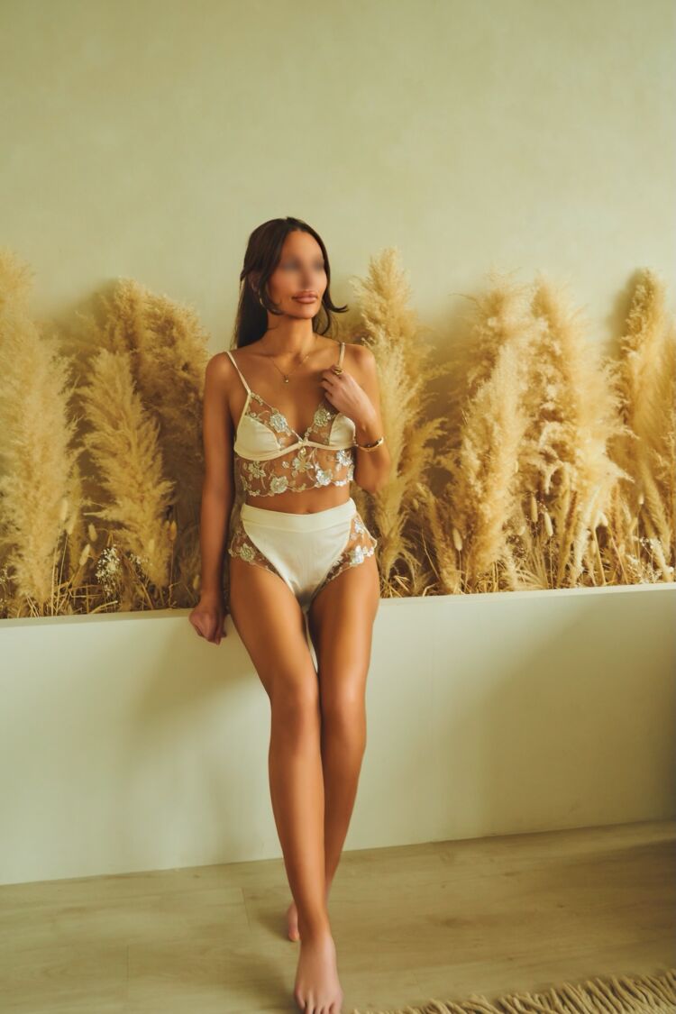 Tanned escort shows off her long legs in her Toronto incall