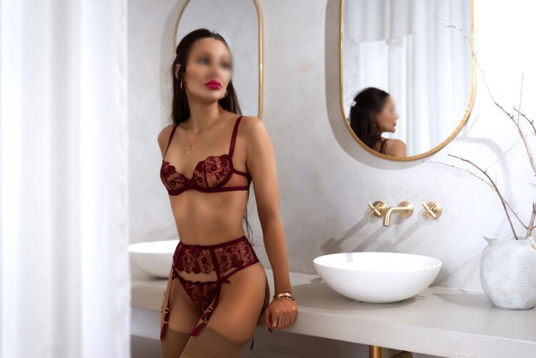 Toronto provider sits on bathroom sink wearing red lingerie, giving her a perfect silhouette figure