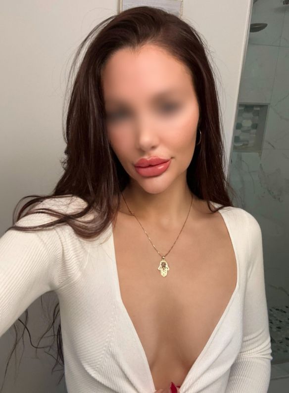 Mediterranean escort gives you the eyes wearing a low cut white sweater